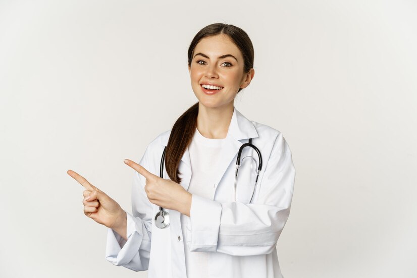 portrait smiling young woman doctor healthcare medical worker pointing fingers left showing clini 1258 88108